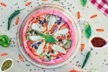 a colorful sliced pizza